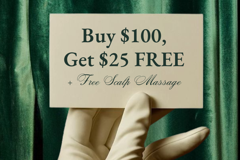 Hand wearing a white glove holding a card with a promotional offer against a green curtain background.